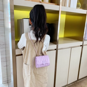 Fashionable girls lilac crossbody bag with heart buckle and quilted pattern on child model