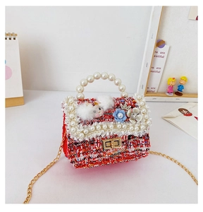 Detail of red tweed girl's handbag with white pearls and luxury woven texture