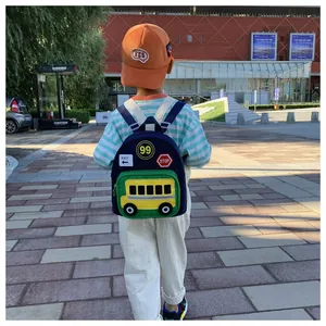 Outdoor view of kids navy backpack with 3D yellow school bus and traffic sign patches