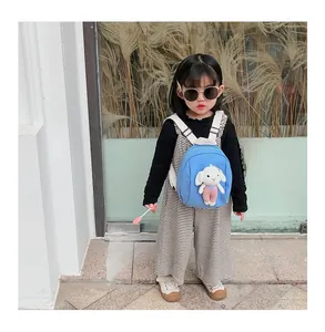 Detail of blue kids backpack featuring a cute 3D plush rabbit doll and urban street style