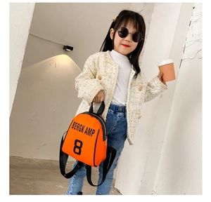 Detail of orange kids backpack with letter print and adjustable black straps