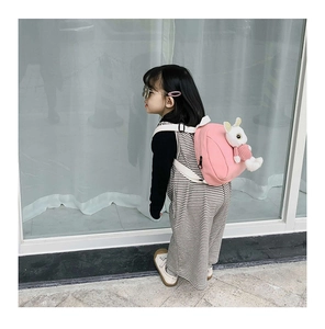Side view of pink toddler backpack with cute 3D bunny doll decoration and adjustable straps