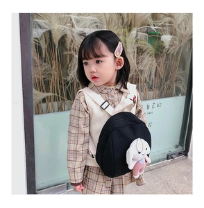 Toddler black fabric backpack featuring a cute white plush bunny charm on the side