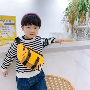 Kids bright yellow chest bag with adjustable black strap shown from a 45-degree angle