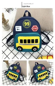 Detail of light blue canvas kids backpack with yellow school bus patch and traffic icons