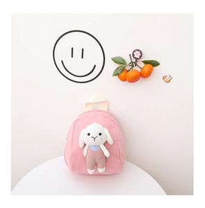 Close-up of pink canvas toddler backpack featuring a cute 3D plush rabbit doll