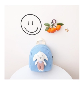 Detail of light blue canvas toddler backpack featuring a 3D plush bunny doll on front