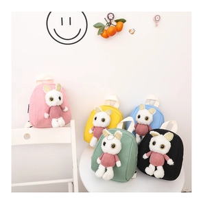 Group display of colorful kids backpacks with cute plush rabbit dolls in a bright room