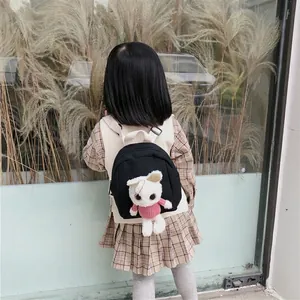 Kids black canvas backpack with plush cat toy and adjustable straps for toddlers