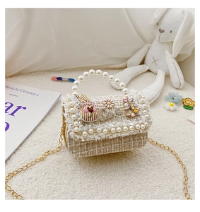 Detail of tweed mini bag with pearl handle and striped rabbit embellishment