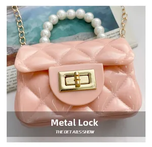 Close-up of pink jelly purse with quilted pattern, pearl handle and gold twist lock