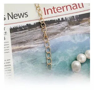 Detailed close-up of white pearls and golden alloy chain clasp on a kids' jelly bag