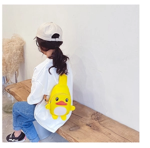 Detail view of yellow duck cartoon chest bag for kids with orange shoulder strap