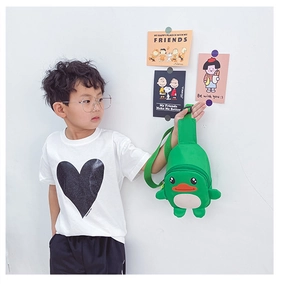 Side view of a green duck cartoon chest bag worn by a child with adjustable strap