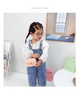 Pink jelly mini handbag for girls with pearl handle and quilted texture on model
