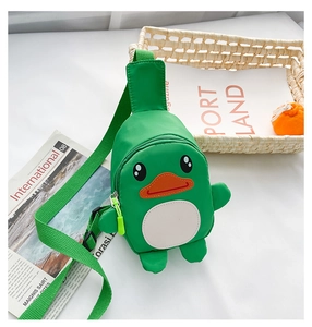 Detail of cute green cartoon duck chest bag with adjustable strap on white surface