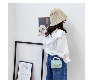 Quilted mint green jelly bag for kids with pearl handle and golden chain strap detail