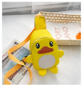 Detail of cute yellow cartoon duck kids crossbody bag with adjustable strap and nylon texture
