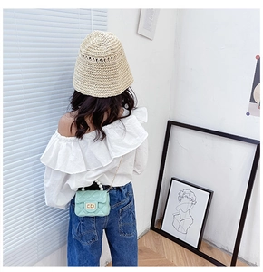 Detail of mint green jelly bag with pearl handle and metal chain for children