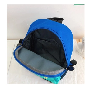 Detail view of the spacious blue and green kids' backpack interior with inner pocket