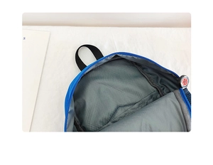 Detail view of the blue car backpack interior with tire-shaped zipper and gray lining