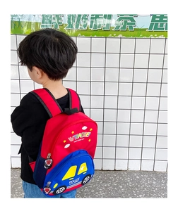 Detail view of a red and blue cartoon police car backpack with adjustable straps for kids