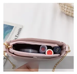 Detail view of pink girls' crossbody bag showing double main compartments and zipper pocket