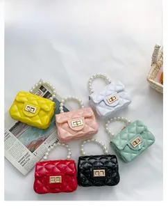 Overhead view of six mini jelly purses with pearl handles and quilted textures