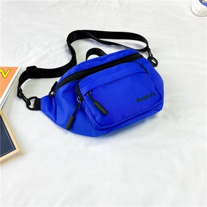 Detail view of royal blue nylon chest bag with adjustable straps and zip compartments