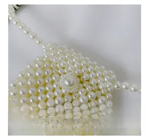 Close-up of elegant handmade white faux pearl weave and intricate beaded texture