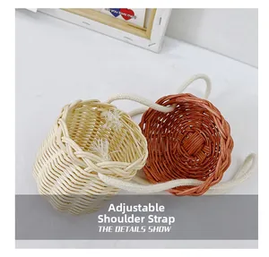 Detail showing two mini woven rattan bags with adjustable white cotton shoulder straps