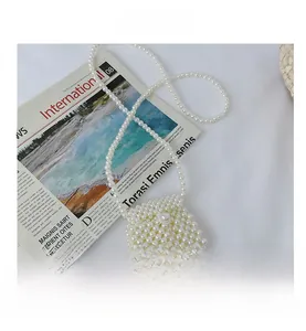 Close-up of white faux pearl woven mini crossbody bag with a square flap and elegant strap