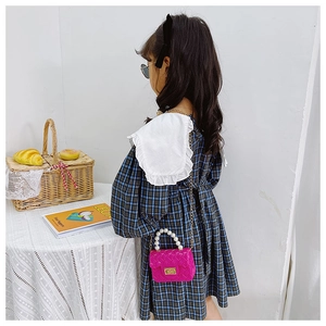 Girl's rose red mini jelly bag with pearl handle and woven texture detail