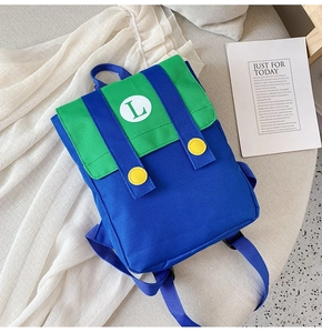 Close-up of canvas school backpack in blue and green with a white L letter emblem