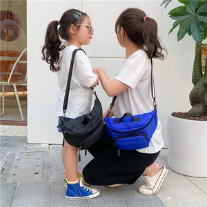 Detail view of durable nylon chest bags in black and royal blue with adjustable straps