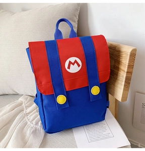 Detail of red and blue cartoon backpack featuring yellow buttons and M logo embroidery