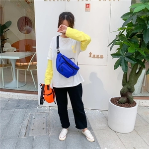 Outdoor shot of royal blue and bright orange nylon chest bags with adjustable straps