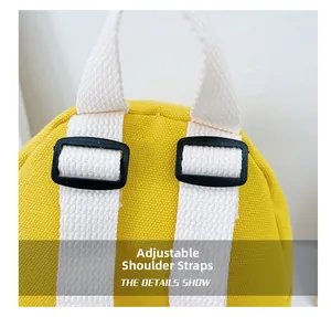 Detail showing adjustable white shoulder straps with black buckles on yellow backpack