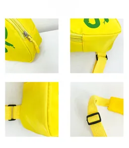 Detail view of yellow crossbody bag showing zipper, stitching, and adjustable strap buckle