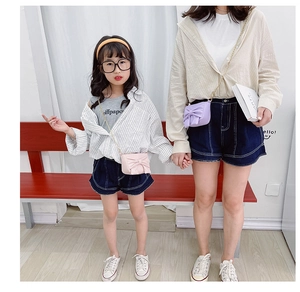 Cute pink and purple crossbody bags with large bows and gold chain straps on models