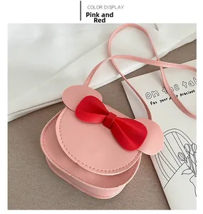 Detail view of pink bow purse for girls featuring cute mouse ears and adjustable strap