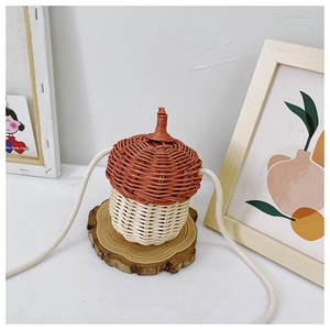 Detailed macro view of acorn-shaped woven bag with brown lid and natural wood background