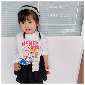 Detailed view of child's white pearl woven crossbody bag with elegant gold chain strap