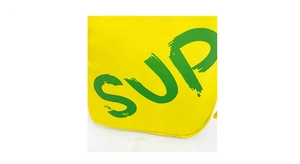 Detail of yellow canvas kids bag featuring green SUP printed letters in street style
