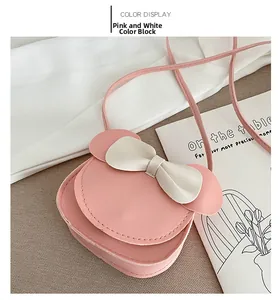 Detail of pink and white mini crossbody bag with bow and round ears for little girls