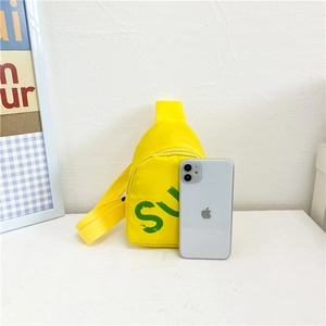 Mini yellow nylon crossbody chest bag with green SU print shown next to a smartphone