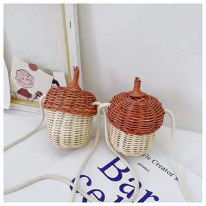 Detailed view of acorn-shaped rattan woven crossbody bags for kids with cotton straps