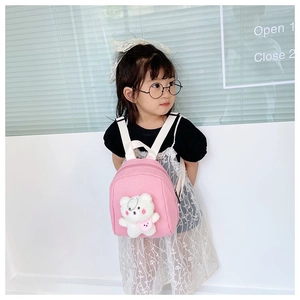 Detail of pink toddler backpack with 3D white teddy bear and soft fabric texture