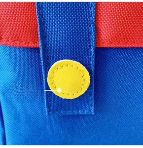 Detailed stitching on canvas backpack with yellow circular patch and color-block design