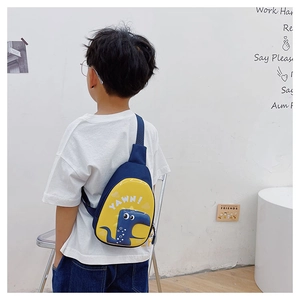 Detail view of a child wearing the dinosaur egg crossbody bag with adjustable strap